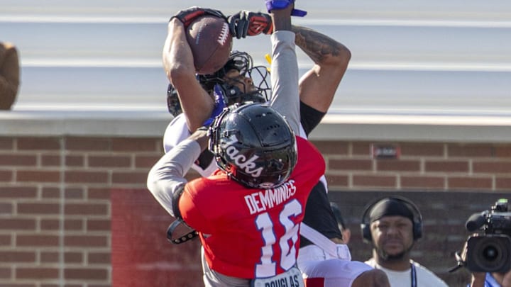 National receiver Reggie Virgil (15) of Texas Tech grabs a pass over National cornerback Charles Demmings at the Senior Bowl.