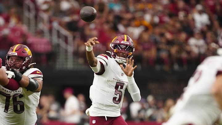 Commanders Jayden Daniels (5) throws for a first down against the Cardinals during a game at State Farm Stadium in Glendale on Sept. 29, 2024. Commanders Jayden Daniels (5) throws for a first down against the Cardinals during a game at State Farm Stadium in Glendale on Sept. 29, 2024.