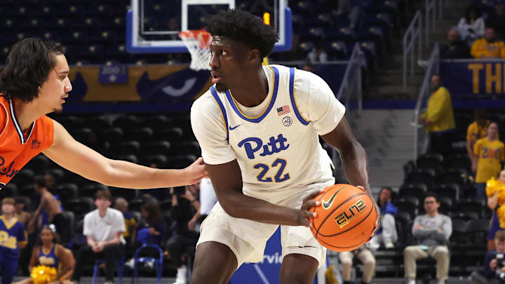 Nov 17, 2025; Pittsburgh, Pennsylvania, USA; Pittsburgh Panthers guard Barry Dunning Jr. (22) handles the ball against Bucknell Bison guard Aleksander Pachucki (left) during the second half at the Petersen Events Center. Mandatory Credit: Charles LeClaire-Imagn Images Nov 17, 2025; Pittsburgh, Pennsylvania, USA; Pittsburgh Panthers guard Barry Dunning Jr. (22) handles the ball against Bucknell Bison guard Aleksander Pachucki (left) during the second half at the Petersen Events Center. Mandatory Credit: Charles LeClaire-Imagn Images