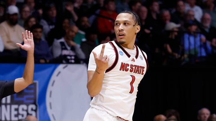 Mar 17, 2026; Dayton, OH, USA; (Editors note: obscene gesture) NC State Wolfpack forward Darrion Williams (1) reacts in the first half against the Texas Longhorns during a first four game of the men's 2026 NCAA Tournament at University of Dayton Arena. Mandatory Credit: Rick Osentoski-Imagn Images