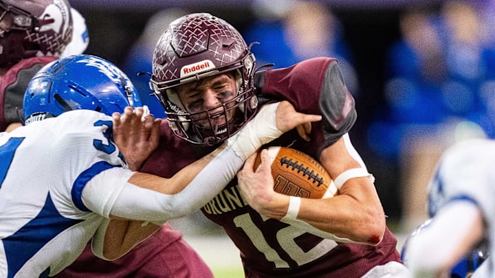 Grundy Center's Judd Jirovsky (12) runs the ball up the middle on Thursday, Nov. 21, 2024, at the UNI-Dome in Cedar Falls, IA.