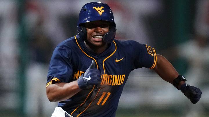 West Virginia Mountaineers base runner Sean Smith heads home to score a run against the ASU Sun Devils during their Big 12 tournament game at Surprise Stadium on May 22, 2026. West Virginia Mountaineers base runner Sean Smith heads home to score a run against the ASU Sun Devils during their Big 12 tournament game at Surprise Stadium on May 22, 2026.
