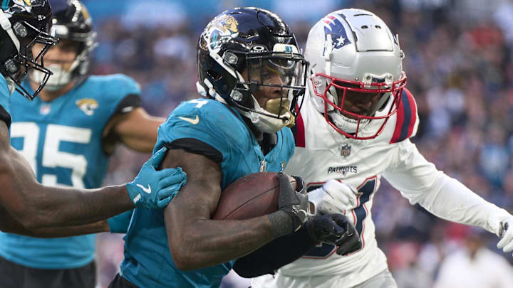 Oct 20, 2024; London, United Kingdom; Jacksonville Jaguars running back Tank Bigsby (4) runs in a touchdown  in the second half during an NFL International Series game at Wembley Stadium. Mandatory Credit: Peter van den Berg-Imagn Images