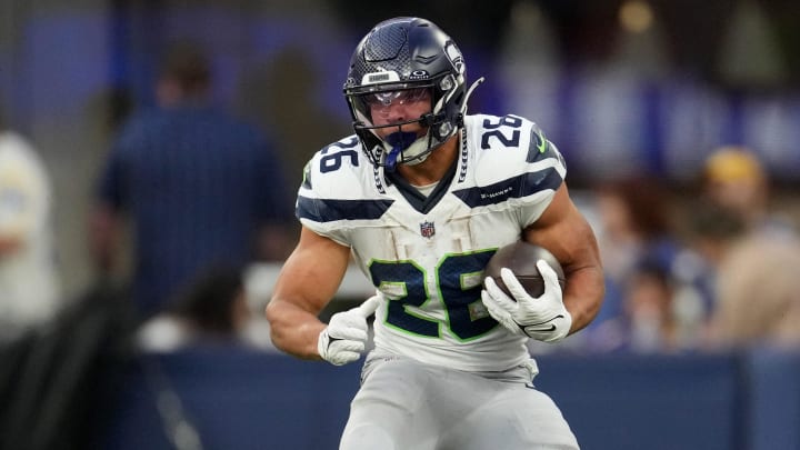 Nov 19, 2023; Inglewood, California, USA; Seattle Seahawks running back Zach Charbonnet (26) runs against Los Angeles Rams cornerback Ahkello Witherspoon (44) in the third quarter at SoFi Stadium. Mandatory Credit: Kirby Lee-USA TODAY Sports