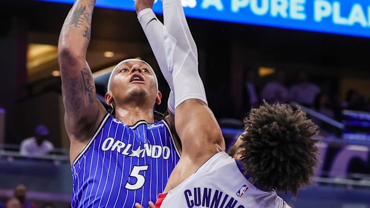 Mar 1, 2026; Orlando, Florida, USA; Orlando Magic forward Paolo Banchero (5) goes to the basket against Detroit Pistons guard Cade Cunningham (2) during the second half at Kia Center. Mandatory Credit: Mike Watters-Imagn Images