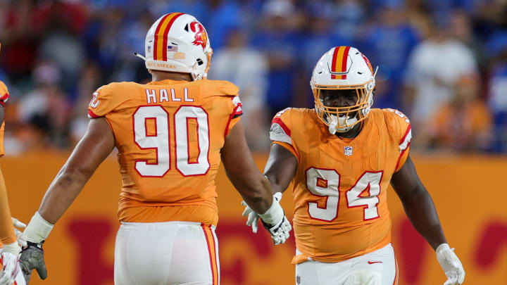 Oct 15, 2023; Tampa, Florida, USA;  Tampa Bay Buccaneers defensive end Logan Hall (90) congratulated defensive tackle Calijah Kancey (94) after a sack against the Detroit Lions in the fourth quarter at Raymond James Stadium. Mandatory Credit: Nathan Ray Seebeck-USA TODAY Sports