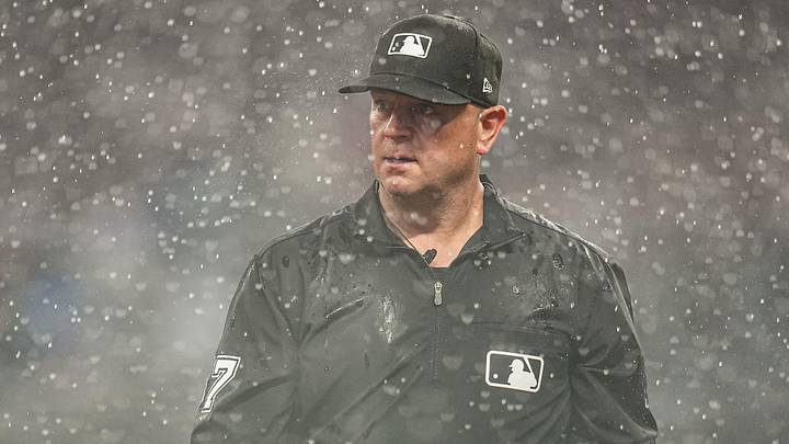 May 24, 2026; Cumberland, Georgia, USA; Umpire Scott Barry (87) walks off the field during a rain delay during the game between the Washington Nationals against the Atlanta Braves during the seventh inning at Truist Park. Mandatory Credit: Dale Zanine-Imagn Images