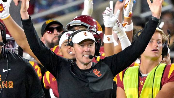 USC Trojans head coach Lincoln Riley and defensive line coach Shaun Nua celebrate on the sideline. 