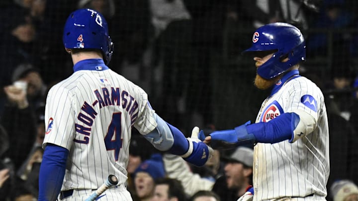 Apr 8, 2025; Chicago, Illinois, USA;  Chicago Cubs first baseman Justin Turner (3) high fives Pete Crow-Armstrong (4) after he  scores during the fifth inning against the Texas Rangers at Wrigley Field