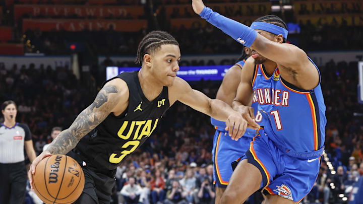 Mar 20, 2024; Oklahoma City, Oklahoma, USA; Utah Jazz guard Keyonte George (3) moves the ball around Oklahoma City Thunder guard Aaron Wiggins (21) during the second half at Paycom Center. Mandatory Credit: Alonzo Adams-Imagn Images
