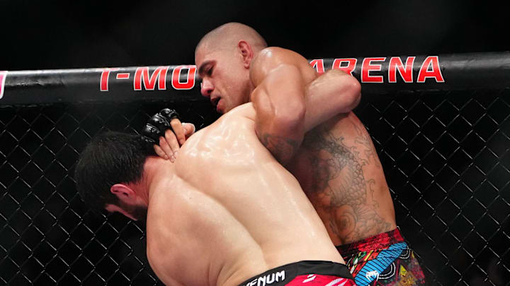 Alex Pereira (red gloves) fights Magomed Ankalaev (blue gloves) during UFC 313 at T-Mobile Arena.