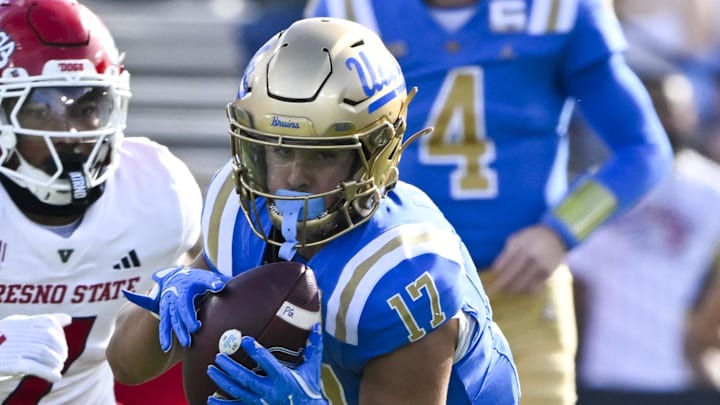 Nov 30, 2024; Pasadena, California, USA; UCLA Bruins wide receiver Logan Loya (17) runs past Fresno State Bulldogs linebacker Phoenix Jackson (7) after catching a short pass in the first quarter at Rose Bowl. Mandatory Credit: Robert Hanashiro-Imagn Images Nov 30, 2024; Pasadena, California, USA; UCLA Bruins wide receiver Logan Loya (17) runs past Fresno State Bulldogs linebacker Phoenix Jackson (7) after catching a short pass in the first quarter at Rose Bowl. Mandatory Credit: Robert Hanashiro-Imagn Images