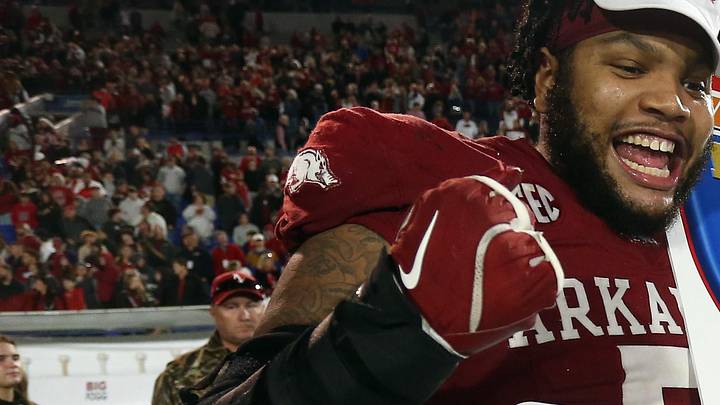 Former Arkansas Razorbacks defensive linemen Cameron Ball reacts after a win
