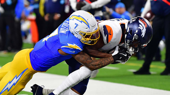 Dec 19, 2024; Inglewood, California, USA; Denver Broncos wide receiver Marvin Mims Jr. (19) runs the ball against Los Angeles Chargers cornerback Kristian Fulton (7) during the first half at SoFi Stadium. Mandatory Credit: Gary A. Vasquez-Imagn Images