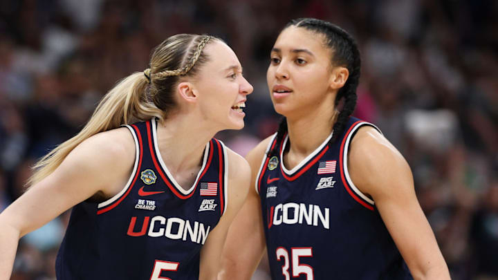 Apr 6, 2025; Tampa, FL, USA; Connecticut Huskies guard Paige Bueckers (5) reacts with teammates guard Ashlynn Shade (12) and guard Azzi Fudd (35) during the second half against the South Carolina Gamecocks of the national championship of the women's 2025 NCAA tournament at Amalie Arena. Mandatory Credit: Nathan Ray Seebeck-Imagn Images