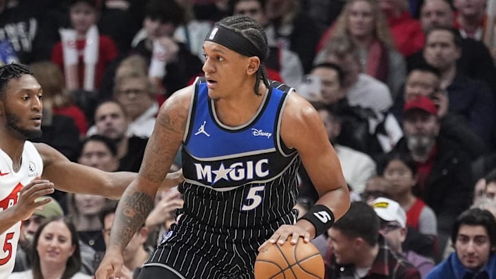 Dec 29, 2025; Toronto, Ontario, CAN; Orlando Magic forward Paolo Banchero (5) controls the ball against Toronto Raptors guard Immanuel Quickley (5) during the first half at Scotiabank Arena. Mandatory Credit: John E. Sokolowski-Imagn Images
