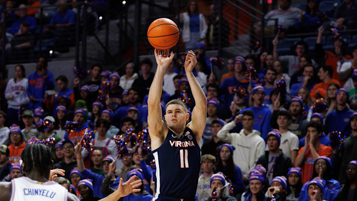 Dec 4, 2024; Gainesville, Florida, USA; Virginia Cavaliers guard Isaac McKneely (11) makes a three point basket over Florida Gators guard Walter Clayton Jr. (1) during the first half at Exactech Arena at the Stephen C. O'Connell Center. Mandatory Credit: Matt Pendleton-Imagn Images Dec 4, 2024; Gainesville, Florida, USA; Virginia Cavaliers guard Isaac McKneely (11) makes a three point basket over Florida Gators guard Walter Clayton Jr. (1) during the first half at Exactech Arena at the Stephen C. O'Connell Center. Mandatory Credit: Matt Pendleton-Imagn Images