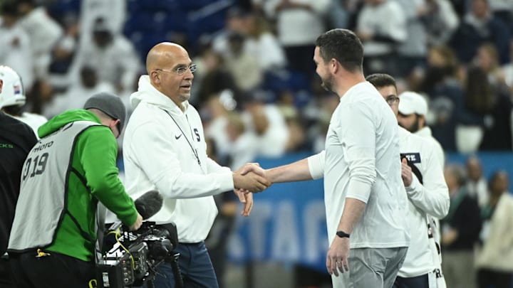 Dec 7, 2024; Indianapolis, IN, USA; Penn State Nittany Lions head coach James Franklin shakes hands with Oregon Ducks head coach Dan Lanning in the 2024 Big Ten Championship game at Lucas Oil Stadium. Mandatory Credit: Robert Goddin-Imagn Images