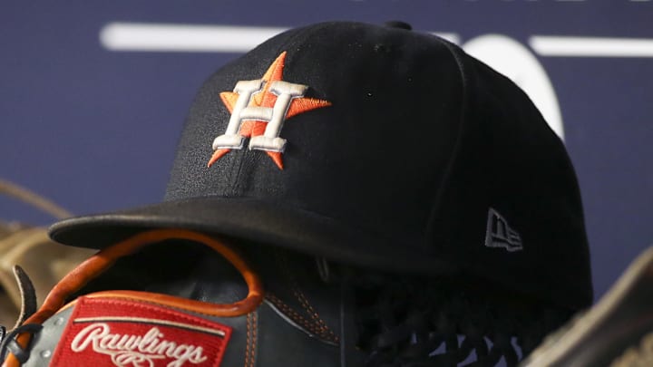 A detailed view of the hat and glove of Houston Astros A detailed view of the hat and glove of Houston Astros