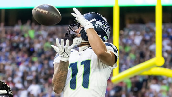 Dec 8, 2024; Glendale, Arizona, USA; Seattle Seahawks wide receiver Jaxon Smith-Njigba (11) catches a touchdown pass against Arizona Cardinals cornerback Garrett Williams (21) in the first half at State Farm Stadium. Images