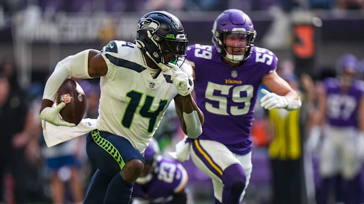 Sep 26, 2021; Minneapolis, Minnesota, USA; Seattle Seahawks wide receiver DK Metcalf (14) runs with the ball during the first quarter against Minnesota Vikings at U.S. Bank Stadium.