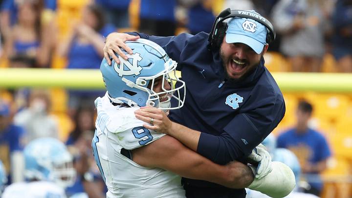 Oct 10, 2026; Pittsburgh, Pennsylvania, USA; North Carolina Tar Heels defensive lineman Melkart Abou Jaoude (9) celebrates with outside linebackers Coach Ty Nichols (right) after a defensive stop against the Pittsburgh Panthers during the fourth quarter at Acrisure Stadium. Mandatory Credit: Charles LeClaire-Imagn Images Oct 10, 2026; Pittsburgh, Pennsylvania, USA; North Carolina Tar Heels defensive lineman Melkart Abou Jaoude (9) celebrates with outside linebackers Coach Ty Nichols (right) after a defensive stop against the Pittsburgh Panthers during the fourth quarter at Acrisure Stadium. Mandatory Credit: Charles LeClaire-Imagn Images