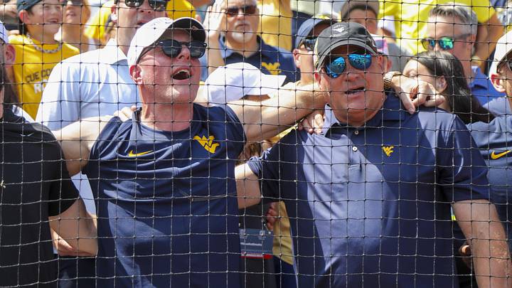 Jun 5, 2026; Morgantown, WV, USA; Pat McAfee and West Virginia head football coach Rich Rodriguez sing “Country Roads” after defeating the Cal Poly Mustangs at Kendrick Family Ballpark. Mandatory Credit: Ben Queen-Imagn Images Jun 5, 2026; Morgantown, WV, USA; Pat McAfee and West Virginia head football coach Rich Rodriguez sing “Country Roads” after defeating the Cal Poly Mustangs at Kendrick Family Ballpark. Mandatory Credit: Ben Queen-Imagn Images