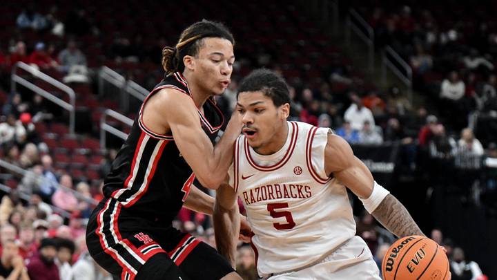 Dec 20, 2025; Newark, New Jersey, USA; Arkansas Razorbacks guard Darius Acuff Jr. (5) tries to drive past Houston Cougars guard Kingston Flemings (4) during the first half at Prudential Center. Dec 20, 2025; Newark, New Jersey, USA; Arkansas Razorbacks guard Darius Acuff Jr. (5) tries to drive past Houston Cougars guard Kingston Flemings (4) during the first half at Prudential Center.