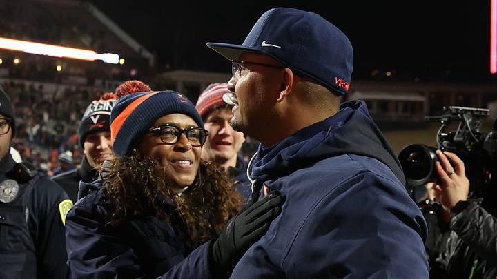 Nov 29, 2025; Charlottesville, Virginia, USA; Virginia Cavaliers head coach Tony Elliott (R) celebrates with Virginia director of athletics Carla Williams (L) on the field after the Cavaliers' game against the Virginia Tech Hokies at Scott Stadium. Mandatory Credit: Geoff Burke-Imagn Images