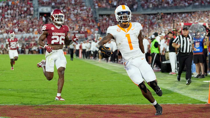 Tennessee Volunteers wide receiver Dont'e Thornton Jr. (1) scores a touchdown in front of Oklahoma Sooners defensive back Kani Walker (26) during a college football game between the University of Oklahoma Sooners (OU) and the Tennessee Volunteers at Gaylord Family - Oklahoma Memorial Stadium in Norman, Okla., Saturday, Sept. 21, 2024. Tennessee Volunteers wide receiver Dont'e Thornton Jr. (1) scores a touchdown in front of Oklahoma Sooners defensive back Kani Walker (26) during a college football game between the University of Oklahoma Sooners (OU) and the Tennessee Volunteers at Gaylord Family - Oklahoma Memorial Stadium in Norman, Okla., Saturday, Sept. 21, 2024.