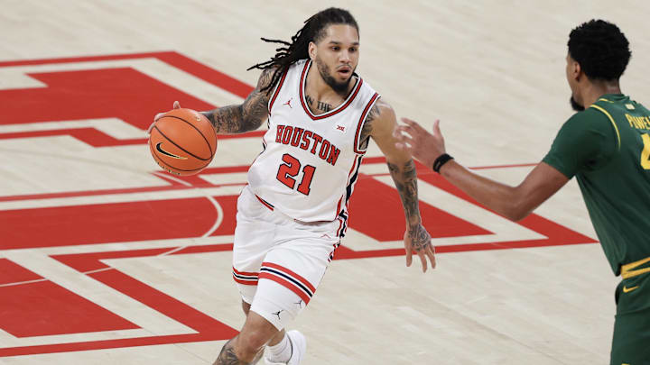 Houston Cougars guard Emanuel Sharp dribbles against Baylor Bears center Caden Powell in the first half at Fertitta Center. 