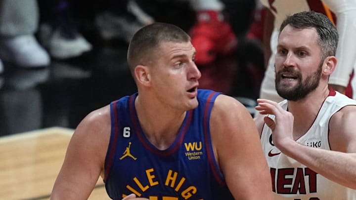 Jun 7, 2023; Miami, Florida, USA; Denver Nuggets center Nikola Jokic (15) attempts to shoot the ball over Miami Heat forward Kevin Love (42) during the third quarter in game three of the 2023 NBA Finals at Kaseya Center. Mandatory Credit: Jim Rassol-Imagn Images