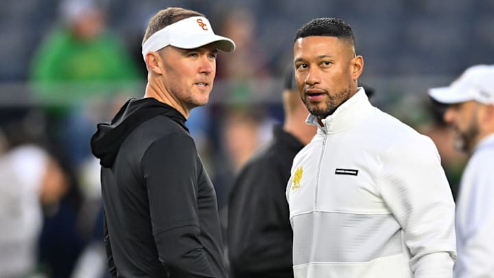 Oct 14, 2023; South Bend, Indiana, USA; USC Trojans head coach Lincoln Riley and Notre Dame Fighting Irish head coach Marcus Freeman chat before the game at Notre Dame Stadium. Mandatory Credit: Matt Cashore-Imagn Images