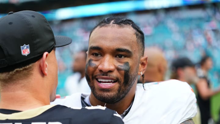 Miami Gardens, Florida, USA; Miami Dolphins quarterback Tua Tagovailoa (1) with New Orleans Saints quarterback Spencer Rattler (2) following a game at Hard Rock Stadium. Mandatory Credit: Rich Storry-Imagn Images