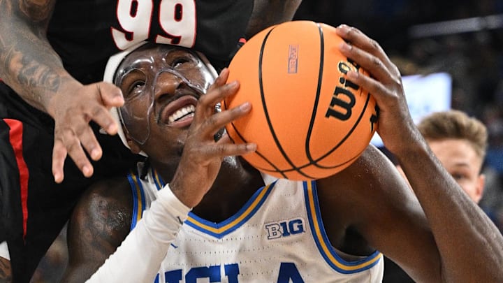 Dec 28, 2024; Inglewood, California, USA; UCLA Bruins guard Eric Dailey Jr. (3) is fouled by Gonzaga Bulldogs guard Khalif Battle (99) during the first half at Intuit Dome. Battle was charged with a flagrant foul on the play. Mandatory Credit: Robert Hanashiro-Imagn Images