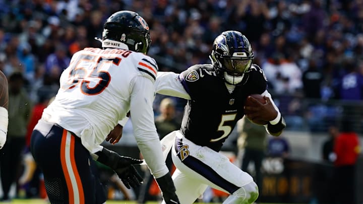 Oct 26, 2025; Baltimore, Maryland, USA; Baltimore Ravens quarterback Tyler Huntley (5) runs with the ball as Chicago Bears defensive end Dayo Odeyingbo (55) chases in the third quarter at M&T Bank Stadium. Mandatory Credit: Geoff Burke-Imagn Images