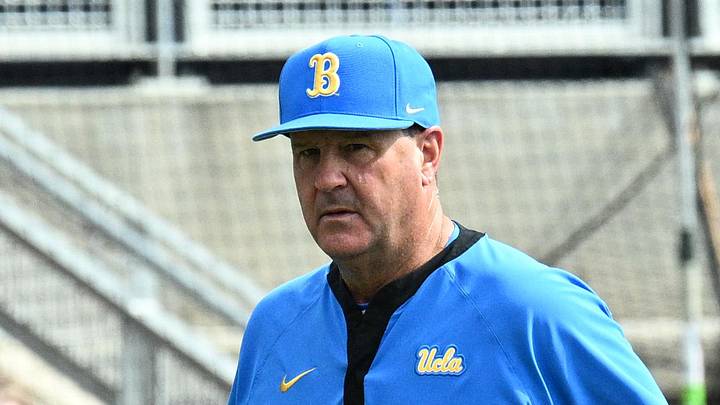 Jun 17, 2025; Omaha, Neb, USA; UCLA Bruins head coach John Savage (22) walks to the dugout before the restart of the game against the LSU Tigers at Charles Schwab Field. Mandatory Credit: Steven Branscombe-Imagn Images Jun 17, 2025; Omaha, Neb, USA; UCLA Bruins head coach John Savage (22) walks to the dugout before the restart of the game against the LSU Tigers at Charles Schwab Field. Mandatory Credit: Steven Branscombe-Imagn Images