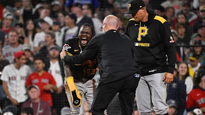 Aug 29, 2025; Boston, Massachusetts, USA; Pittsburgh Pirates second baseman Ronny Simon (63) is checked by medical staff after sliding into home plate against the Boston Red Sox during the eighth inning at Fenway Park. Mandatory Credit: Eric Canha-Imagn Images