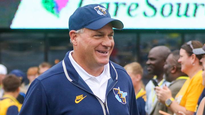 Sep 27, 2025; Morgantown, West Virginia, USA; West Virginia Mountaineers head coach Rich Rodriguez walks on the field and greets fans before their game against the Utah Utes at Milan Puskar Stadium. Mandatory Credit: Ben Queen-Imagn Images