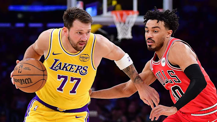 Mar 12, 2026; Los Angeles, California, USA; Los Angeles Lakers guard Luka Doncic (77) moves the ball against Chicago Bulls guard Tre Jones (30) during the first half at Crypto.com Arena. Mandatory Credit: Gary A. Vasquez-Imagn Images