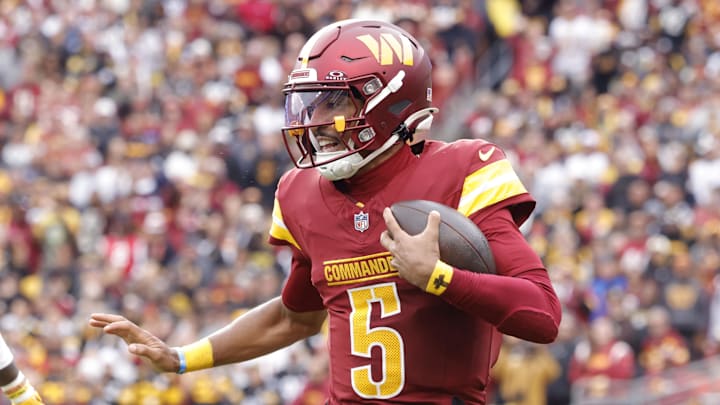 Nov 10, 2024; Landover, Maryland, USA; Washington Commanders quarterback Jayden Daniels (5) carries the ball as Pittsburgh Steelers linebacker Patrick Queen (6) defends during the first half at Northwest Stadium. Mandatory Credit: Amber Searls-Imagn Images