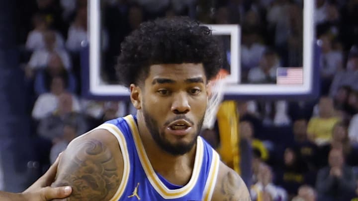 Feb 14, 2026; Ann Arbor, Michigan, USA; UCLA Bruins guard Donovan Dent (2) dribbles defended by Michigan Wolverines guard Trey McKenney (1) in the second half at Crisler Center. Mandatory Credit: Rick Osentoski-Imagn Images
