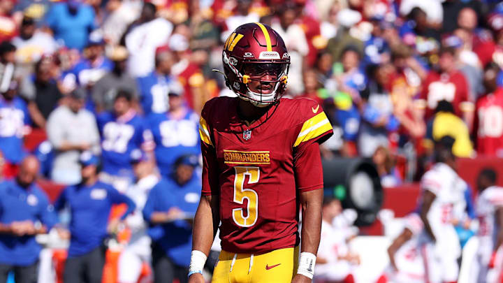 Sep 15, 2024; Landover, Maryland, USA; Washington Commanders quarterback Jayden Daniels (5) waits for a play call during the third quarter against the New York Giants at Commanders Field. Mandatory Credit: Peter Casey-Imagn Images