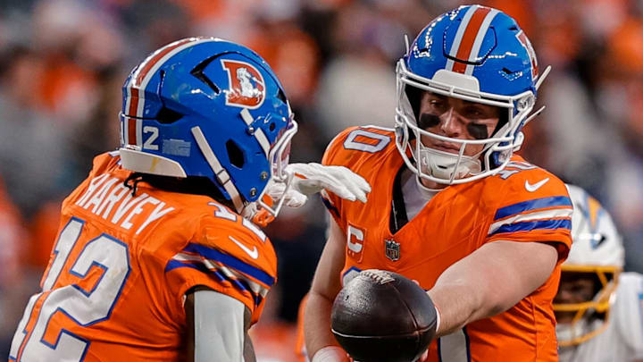 Jan 4, 2026; Denver, Colorado, USA; Denver Broncos quarterback Bo Nix (10) hands the ball off to running back RJ Harvey (12) in the third quarter against the Los Angeles Chargers at Empower Field at Mile High. Mandatory Credit: Isaiah J. Downing-Imagn Images