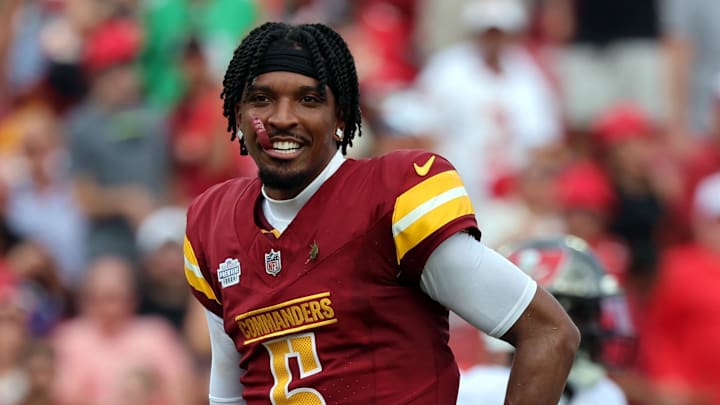 Sep 8, 2024; Tampa, Florida, USA;  Washington Commanders quarterback Jayden Daniels (5) looks on after he lost his helmet against the Tampa Bay Buccaneers during the first half at Raymond James Stadium. Mandatory Credit: Kim Klement Neitzel-Imagn Images