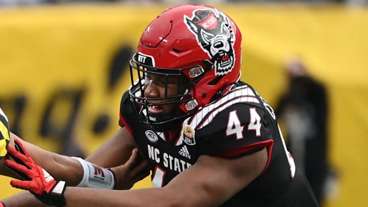 Dec 30, 2022; Charlotte, NC, USA; Maryland Terrapins quarterback Taulia Tagovailoa (3) scrambles as North Carolina State Wolfpack defensive lineman Brandon Cleveland (44) defends in the fourth quarter in the 2022 Duke's Mayo Bowl at Bank of America Stadium. Mandatory Credit: Bob Donnan-Imagn Images Dec 30, 2022; Charlotte, NC, USA; Maryland Terrapins quarterback Taulia Tagovailoa (3) scrambles as North Carolina State Wolfpack defensive lineman Brandon Cleveland (44) defends in the fourth quarter in the 2022 Duke's Mayo Bowl at Bank of America Stadium. Mandatory Credit: Bob Donnan-Imagn Images