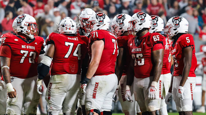 Nov 21, 2025; Raleigh, North Carolina, USA; NC State Wolfpack huddles during the second half of the game against Florida State Seminoles at Carter-Finley Stadium. Mandatory Credit: Jaylynn Nash-Imagn Images