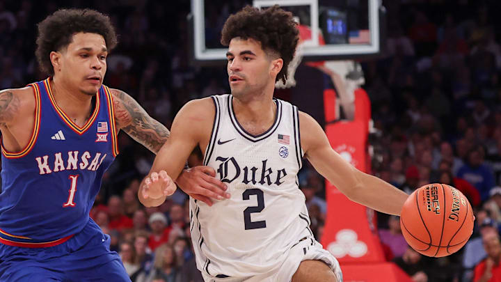 Nov 18, 2025; New York, New York, USA; Duke Blue Devils guard Cayden Boozer (2) dribbles as Kansas Jayhawks guard Jayden Dawson (1) defends during the second half at Madison Square Garden. Mandatory Credit: Vincent Carchietta-Imagn Images Nov 18, 2025; New York, New York, USA; Duke Blue Devils guard Cayden Boozer (2) dribbles as Kansas Jayhawks guard Jayden Dawson (1) defends during the second half at Madison Square Garden. Mandatory Credit: Vincent Carchietta-Imagn Images