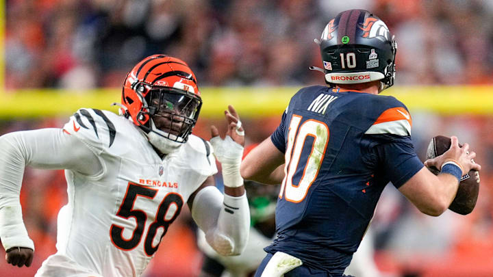 Denver Broncos quarterback Bo Nix (10) outruns Cincinnati Bengals defensive end Joseph Ossai (58) in the first quarter of the NFL Week 4 Monday Night Football game between the Denver Broncos and the Cincinnati Bengals at Empower Field at Mile High in Denver on Monday, Sept. 29, 2025.