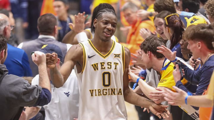 Mar 6, 2026; Morgantown, West Virginia, USA; West Virginia Mountaineers forward Brenen Lorient (0) celebrates with fans after defeating the UCF Knights at Hope Coliseum. Mandatory Credit: Ben Queen-Imagn Images